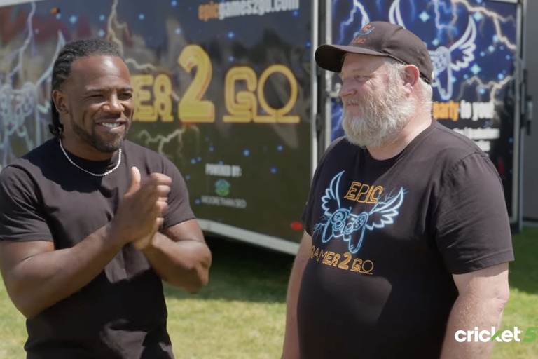 Xavier Woods talking with owner of Epic Games2Go for Cricket's Small Business Superstars