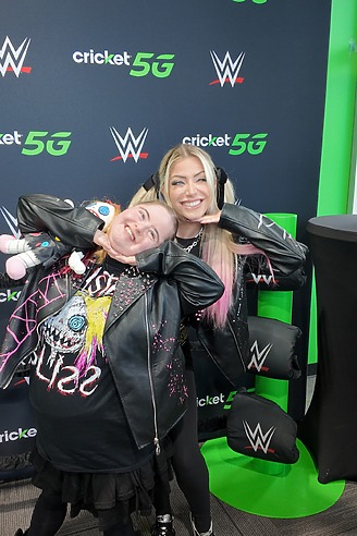 WWE Superstar fan cheesing with a young fan