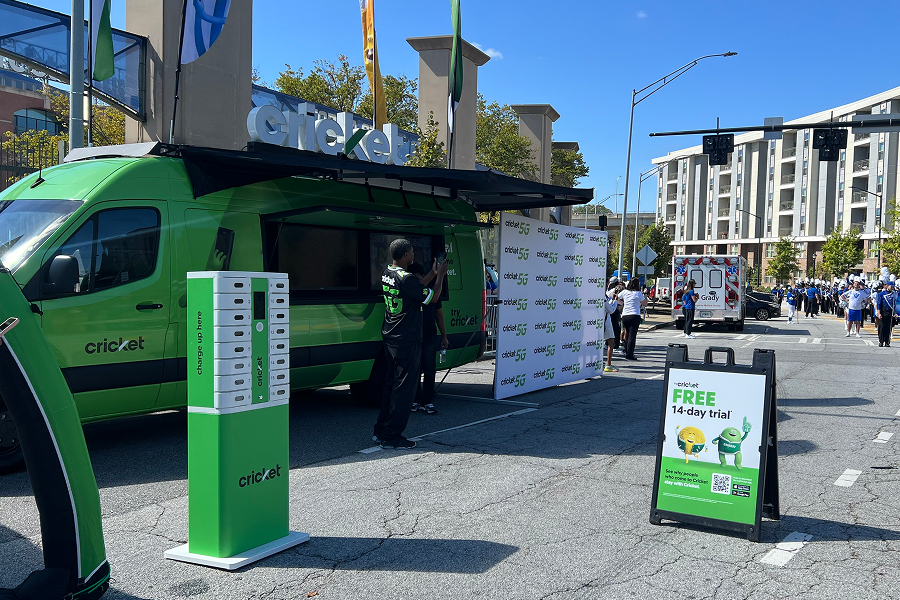 Cricket Wireless branded van and free phone charging station set up outside Georgia State University's stadium during a game-day tailgate event