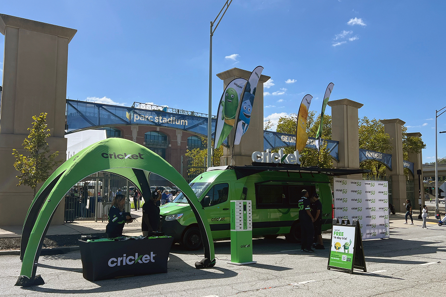 Cricket Wireless game-day activation setup featuring a branded tent, van, phone charging station, and Cricket 5G signage outside Center Parc Stadium