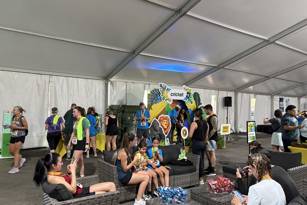 Runners relaxing in the Cricket lounge tent after the 2025 Run Like Wild 5K at Zoo Atlanta