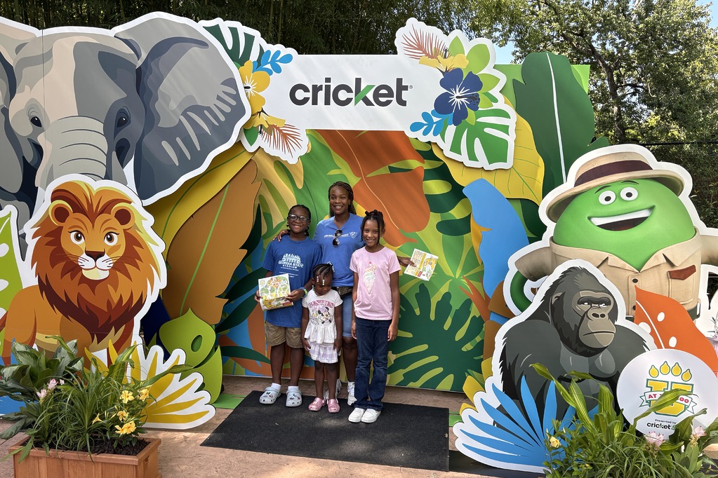 Family posing at the Cricket jungle photo booth at U at the Zoo, presented by Cricket Wireless