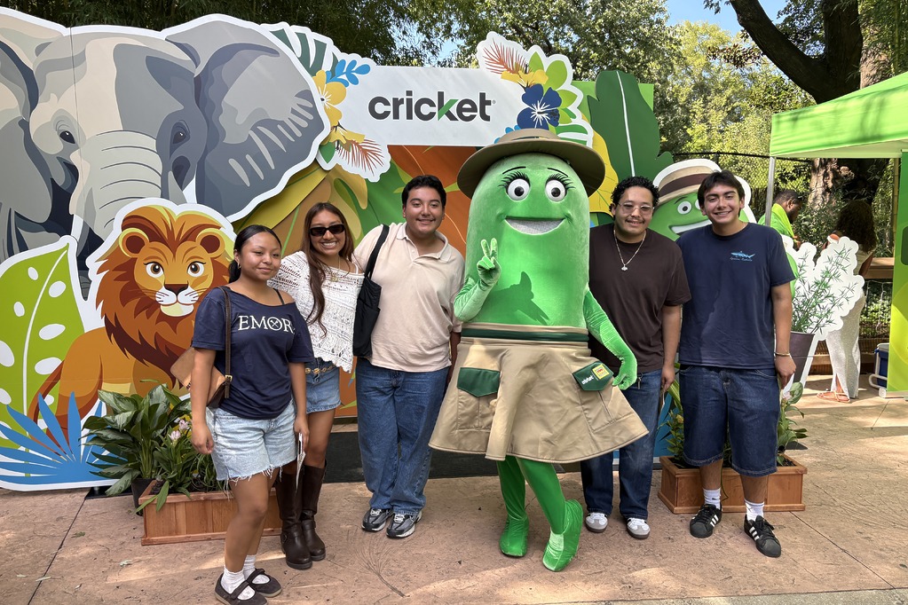 Guests posing with Cricket character Rose at the U at the Zoo photo booth at Zoo Atlanta