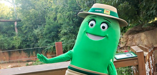 Cricket character in a safari hat waving outside an animal habitat at Zoo Atlanta